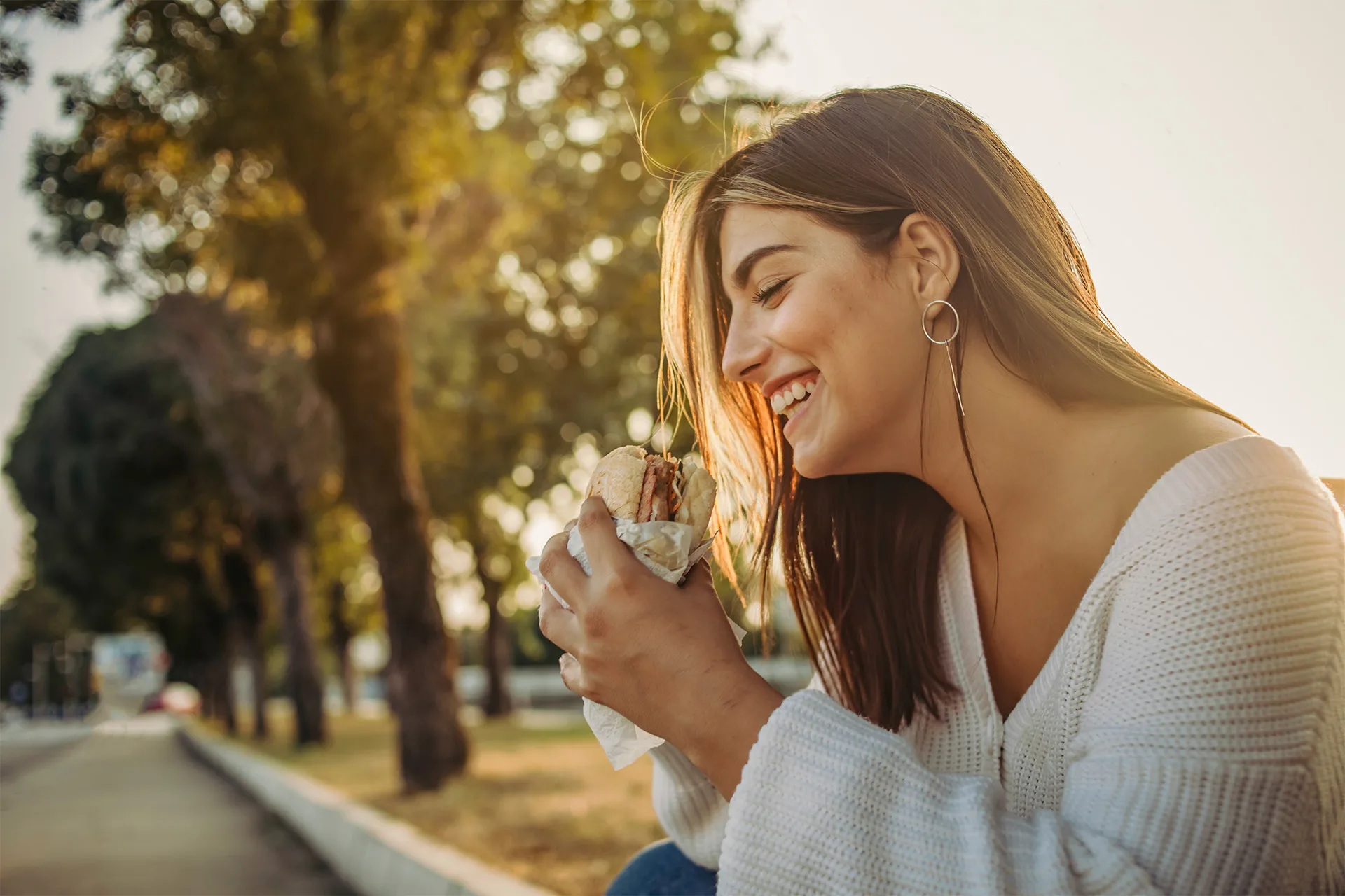 Woman Eating Sandwhich Outside