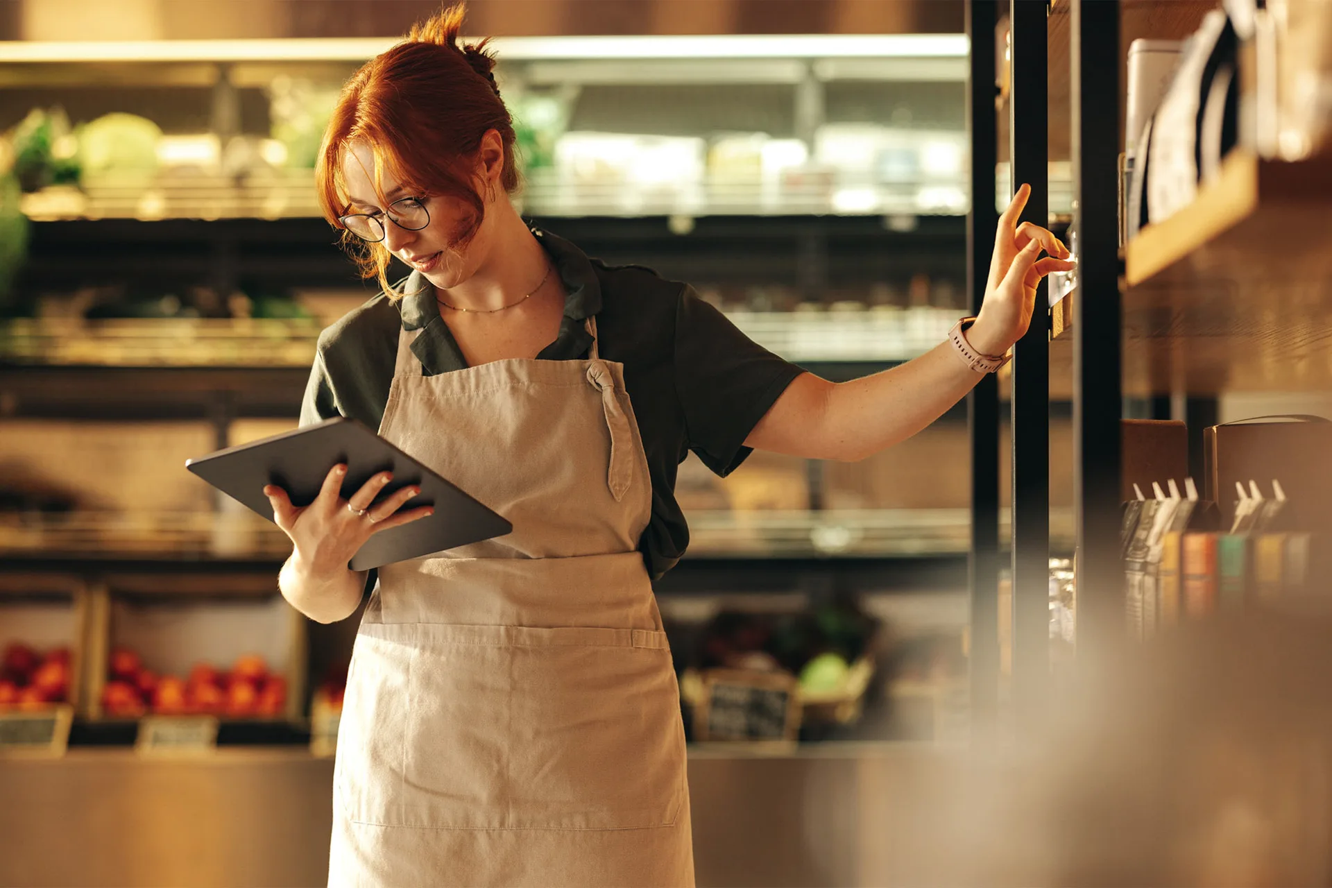 Woman In Market Looking At Ipad